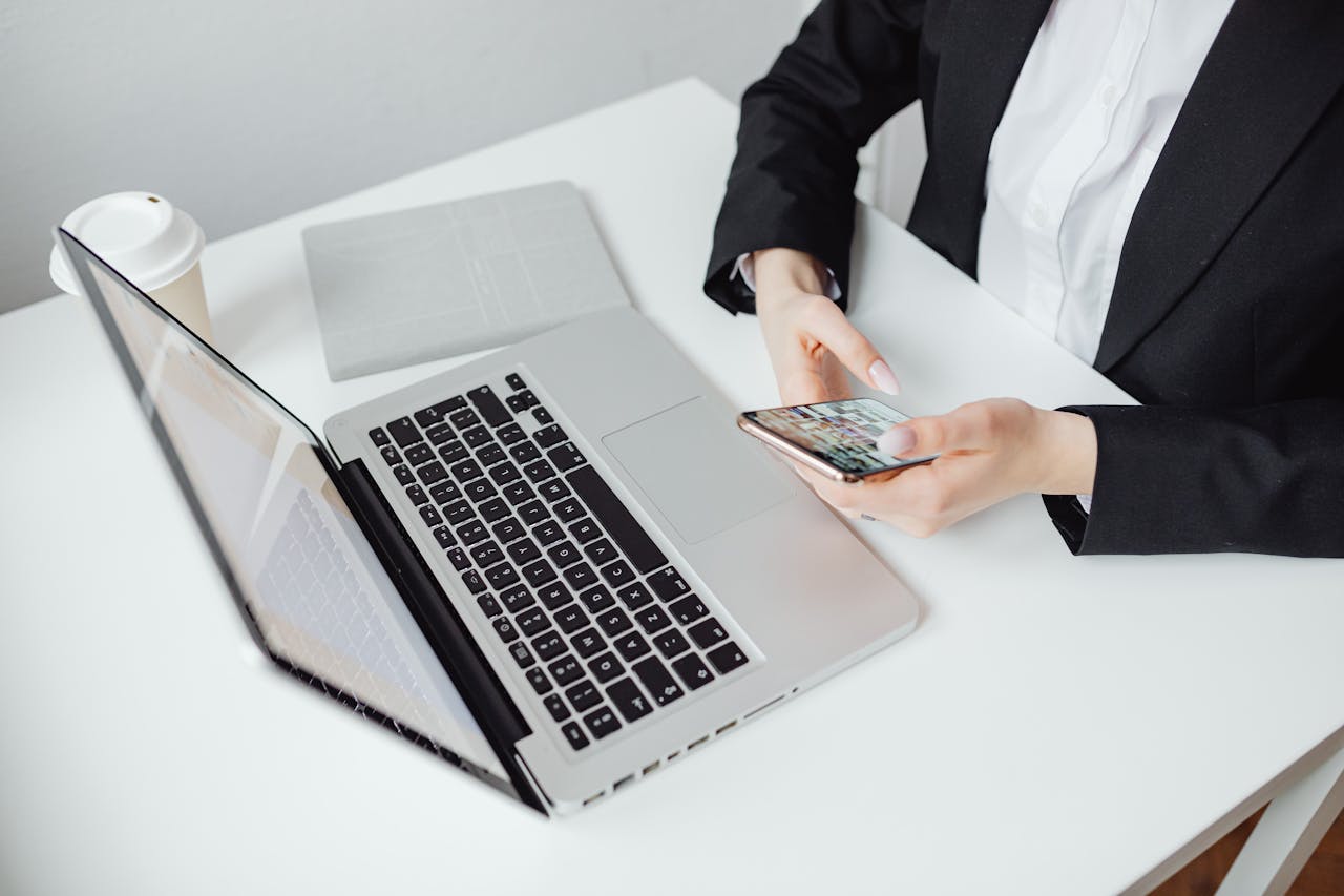 Person in Black Blazer Holding a Smartphone